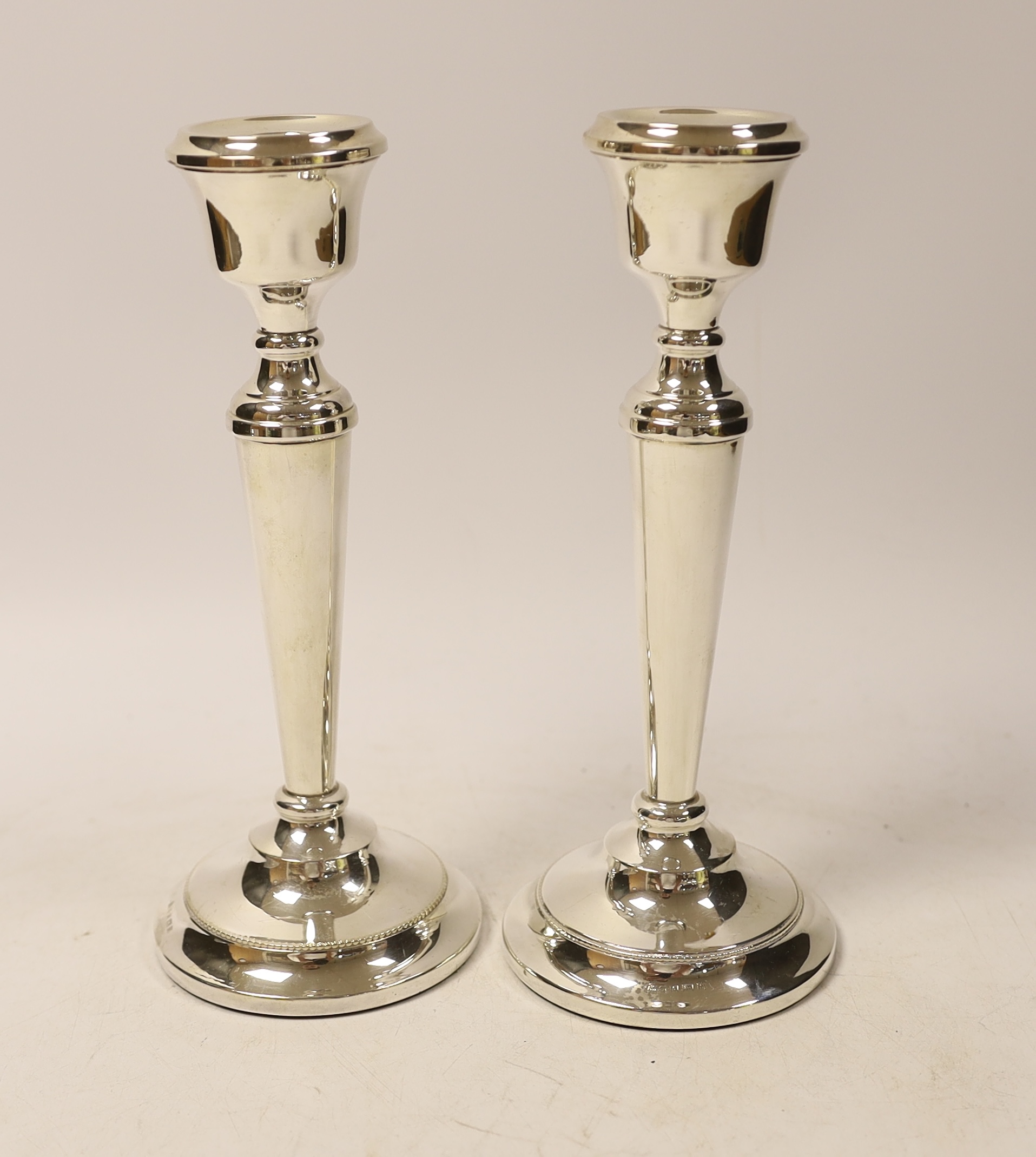 A pair of Elizabeth II silver mounted candlesticks, Birmingham, 1967, 21.5cm, weighted.